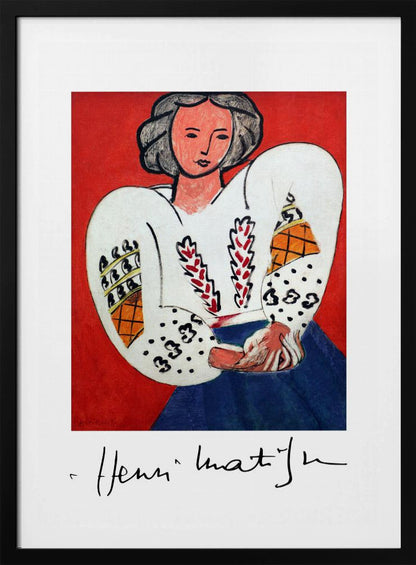 A framed art print of Henri Matisse's 'La Blouse Roumaine' (The Romanian Blouse). The painting depicts a woman with dark, styled hair against a vibrant solid red background. She is wearing a voluminous white blouse with puffy, intricately decorated sleeves and a dark blue skirt. Her hands are clasped in front of her. Below the image is the signature 'Henri Matisse'. Wall Art