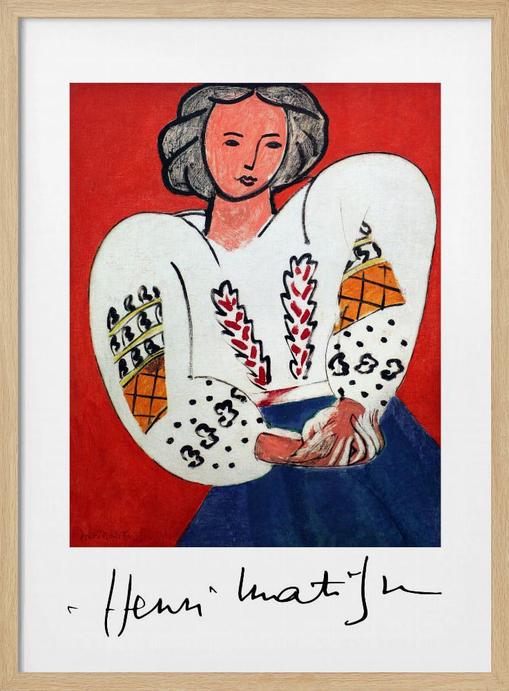 A framed art print of Henri Matisse's 'La Blouse Roumaine' (The Romanian Blouse). The painting depicts a woman with dark, styled hair against a vibrant solid red background. She is wearing a voluminous white blouse with puffy, intricately decorated sleeves and a dark blue skirt. Her hands are clasped in front of her. Below the image is the signature 'Henri Matisse'. Wall Art