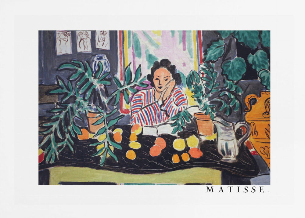 A framed print of the painting 'Woman with a Book' by Henri Matisse. The artwork features a woman in a red, white, and blue striped shirt sitting at a dark table filled with potted green plants and colorful fruit. She rests her head on her hand, looking out from the painting in a Fauvist style with bold colors and expressive brushwork. Poster