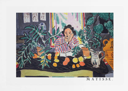 A framed print of the painting 'Woman with a Book' by Henri Matisse. The artwork features a woman in a red, white, and blue striped shirt sitting at a dark table filled with potted green plants and colorful fruit. She rests her head on her hand, looking out from the painting in a Fauvist style with bold colors and expressive brushwork. Poster