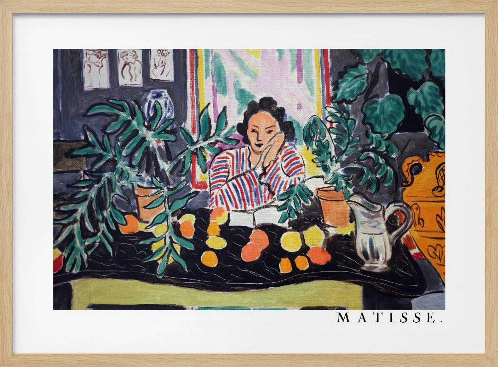 A framed print of the painting 'Woman with a Book' by Henri Matisse. The artwork features a woman in a red, white, and blue striped shirt sitting at a dark table filled with potted green plants and colorful fruit. She rests her head on her hand, looking out from the painting in a Fauvist style with bold colors and expressive brushwork. Poster