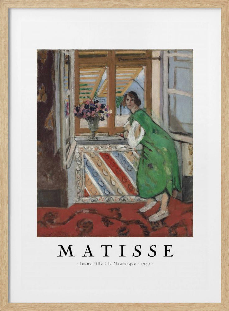 A framed art print of Henri Matisse's painting 'Jeune Fille à la Mauresque - 1939'. The painting shows a woman in a vibrant green dress standing in a room and looking out of an open window with shutters. A red patterned rug covers the floor, and a vase of flowers sits on the windowsill. Poster