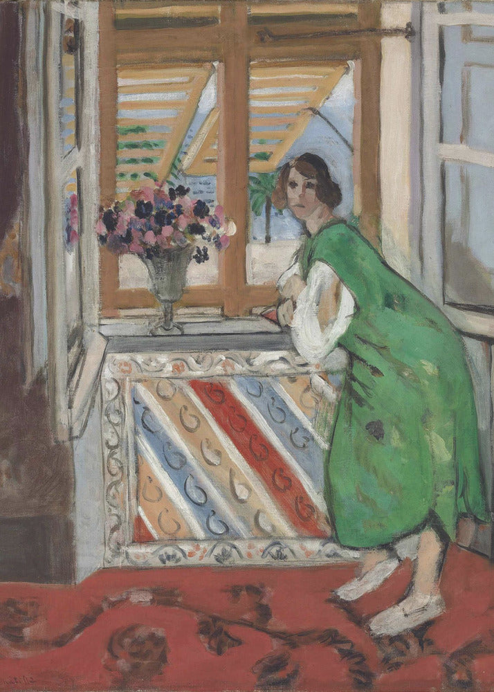 A painting by Henri Matisse depicting a woman in a loose green dress leaning on a windowsill and looking towards the viewer. Outside the open window with tan shutters, a sunny scene with a palm tree is visible. A vase of flowers sits on the sill above a colorful striped panel, and a red patterned rug covers the floor. Print