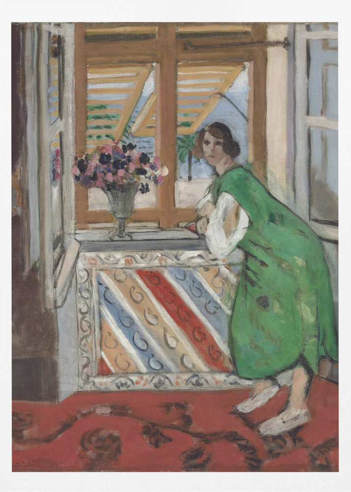 A painting by Henri Matisse depicting a woman in a loose green dress leaning on a windowsill and looking towards the viewer. Outside the open window with tan shutters, a sunny scene with a palm tree is visible. A vase of flowers sits on the sill above a colorful striped panel, and a red patterned rug covers the floor. Print