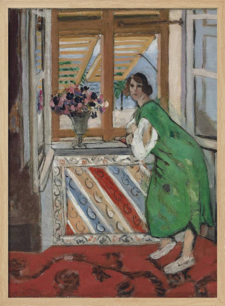 A painting by Henri Matisse depicting a woman in a loose green dress leaning on a windowsill and looking towards the viewer. Outside the open window with tan shutters, a sunny scene with a palm tree is visible. A vase of flowers sits on the sill above a colorful striped panel, and a red patterned rug covers the floor. Print