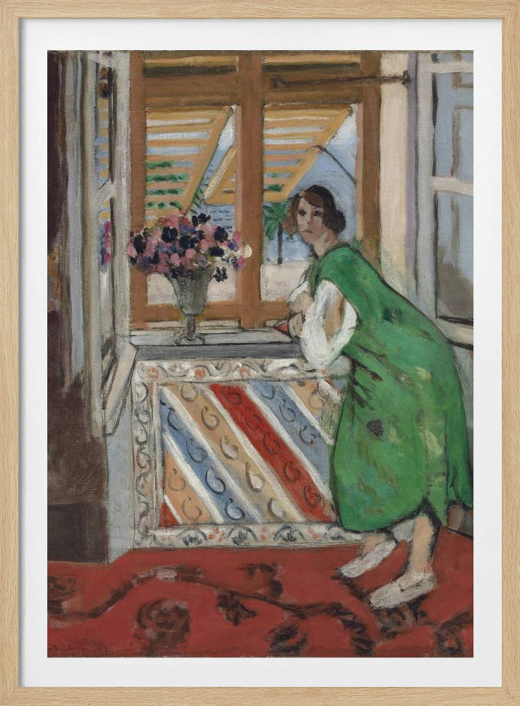 A painting by Henri Matisse depicting a woman in a loose green dress leaning on a windowsill and looking towards the viewer. Outside the open window with tan shutters, a sunny scene with a palm tree is visible. A vase of flowers sits on the sill above a colorful striped panel, and a red patterned rug covers the floor. Print