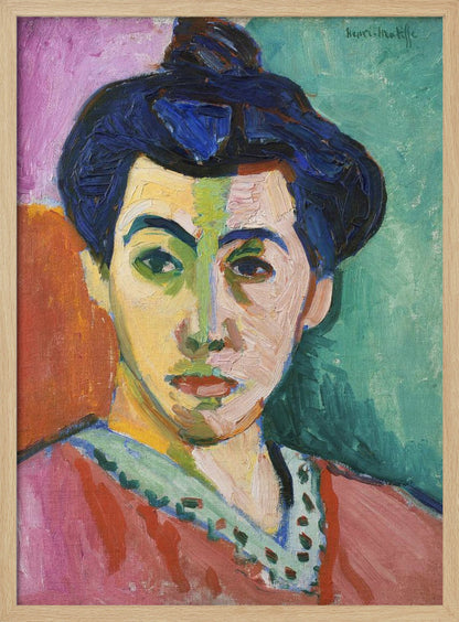 A Fauvist portrait painting by Henri Matisse, 'The Green Stripe,' featuring a woman with dark hair in an updo. Her face is strikingly rendered with unrealistic colors, bisected by a prominent green stripe. The background is composed of bold, flat planes of pink, orange, and teal. Print