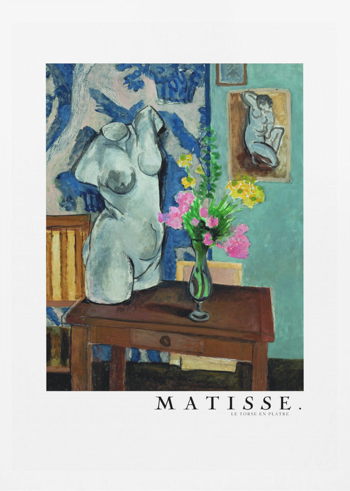 A framed art print of Henri Matisse's painting 'Le Torse en Plâtre'. The still life features a white plaster female torso sculpture next to a dark brown wooden table with a vase of pink and yellow flowers. The background consists of a blue and white patterned tapestry and a teal wall with a small framed nude drawing. Print