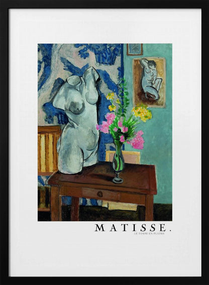 A framed art print of Henri Matisse's painting 'Le Torse en Plâtre'. The still life features a white plaster female torso sculpture next to a dark brown wooden table with a vase of pink and yellow flowers. The background consists of a blue and white patterned tapestry and a teal wall with a small framed nude drawing. Print