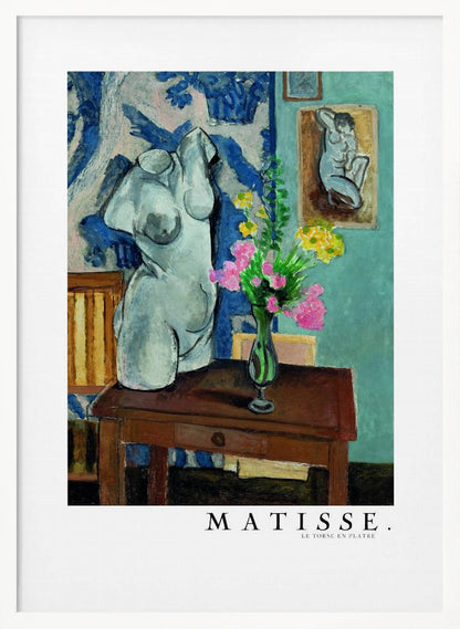 A framed art print of Henri Matisse's painting 'Le Torse en Plâtre'. The still life features a white plaster female torso sculpture next to a dark brown wooden table with a vase of pink and yellow flowers. The background consists of a blue and white patterned tapestry and a teal wall with a small framed nude drawing. Print