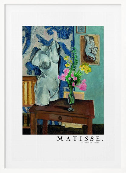 A framed art print of Henri Matisse's painting 'Le Torse en Plâtre'. The still life features a white plaster female torso sculpture next to a dark brown wooden table with a vase of pink and yellow flowers. The background consists of a blue and white patterned tapestry and a teal wall with a small framed nude drawing. Print