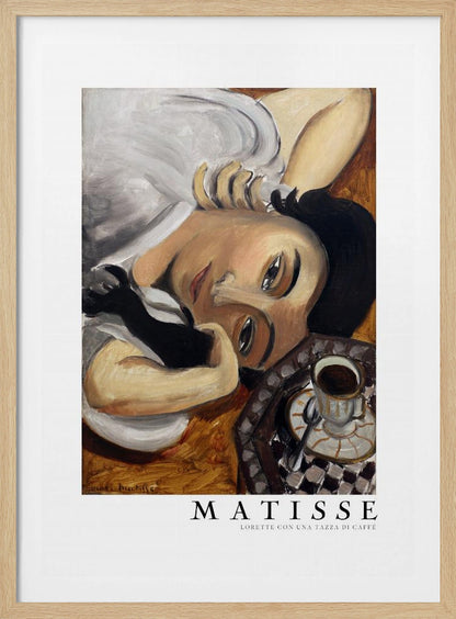 A framed art print of Henri Matisse's painting, 'Lorette con una tazza di caffè' (Lorette with a Cup of Coffee). The portrait features a woman with dark hair lying down, gazing directly at the viewer, with a cup of coffee on a checkered saucer beside her. The artist's name and the title are printed below the image. Decor