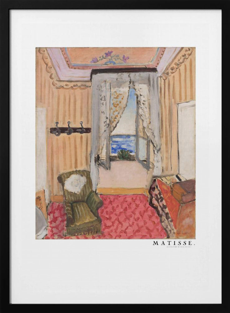 A framed print of a painting by Henri Matisse. The artwork depicts an interior room scene with peach-colored walls, a vibrant pink and red patterned rug, and an armchair. An open window with lace curtains offers a view of the blue sea. Decor