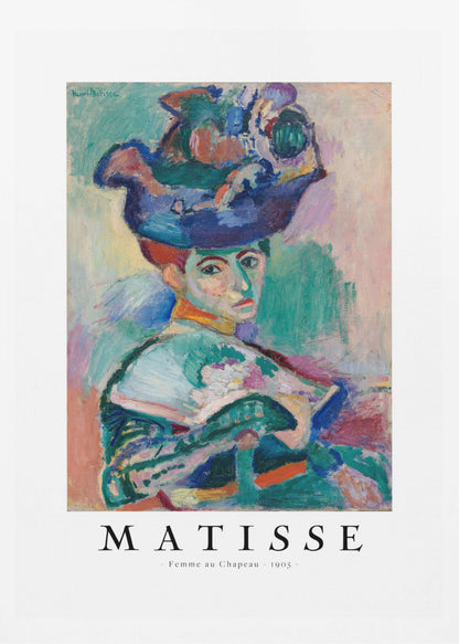 A framed art print of Henri Matisse's famous 1905 Fauvist painting, 'Femme au Chapeau' (Woman with a Hat). The portrait features a woman with an extravagantly decorated, colorful hat, painted with bold, non-naturalistic colors and expressive brushstrokes. Print