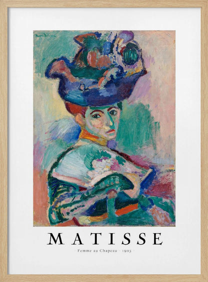 A framed art print of Henri Matisse's famous 1905 Fauvist painting, 'Femme au Chapeau' (Woman with a Hat). The portrait features a woman with an extravagantly decorated, colorful hat, painted with bold, non-naturalistic colors and expressive brushstrokes. Print