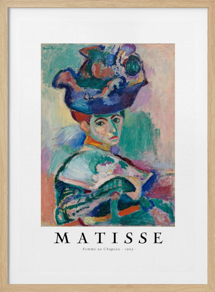 A framed art print of Henri Matisse's famous 1905 Fauvist painting, 'Femme au Chapeau' (Woman with a Hat). The portrait features a woman with an extravagantly decorated, colorful hat, painted with bold, non-naturalistic colors and expressive brushstrokes. Print