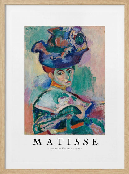 A framed art print of Henri Matisse's famous 1905 Fauvist painting, 'Femme au Chapeau' (Woman with a Hat). The portrait features a woman with an extravagantly decorated, colorful hat, painted with bold, non-naturalistic colors and expressive brushstrokes. Print