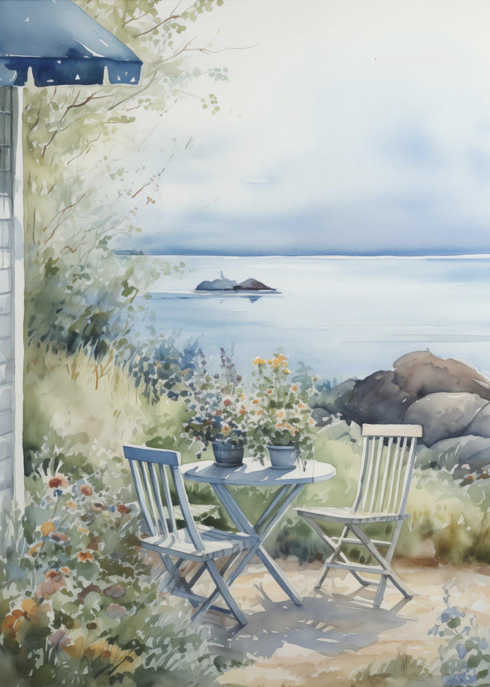 A watercolor painting of a tranquil coastal scene. A light blue bistro table and two matching chairs sit in a lush garden filled with flowers, overlooking a calm body of water. In the distance, a small island is visible under a soft, hazy sky. Part of a house with a blue awning can be seen on the left. Print