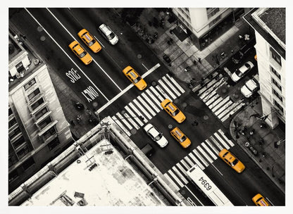 An aerial, black and white photograph of a bustling New York City intersection, with the iconic yellow taxi cabs highlighted in a vibrant selective color. Pedestrians cross the street as cars and a bus navigate the busy roads between tall buildings. Wall Art