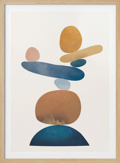 An abstract art print in a thin black frame featuring a stack of colorful, organic shapes resembling balanced stones against a white background. The forms are in various shades of blue, earthy brown, ochre, and a muted pink, creating a sense of calm and equilibrium. Artwork