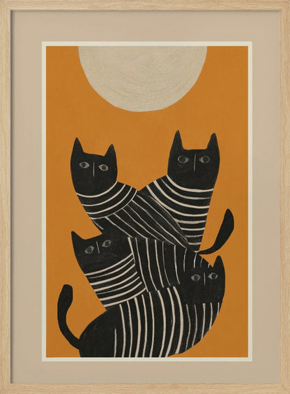 A framed art print of a stylized illustration featuring four black cats with white striped bodies stacked together. They are set against a solid orange background with a large, textured, cream-colored moon or sun at the top. Artwork