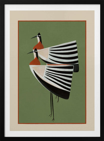A framed art print featuring two highly stylized birds standing against a solid sage green background. The birds have boat-shaped bodies with bold black and white stripes, orange chests, and long thin black legs and beaks. Wall Art