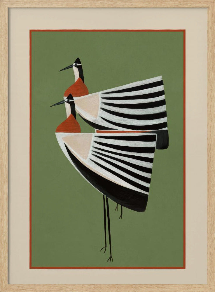 A framed art print featuring two highly stylized birds standing against a solid sage green background. The birds have boat-shaped bodies with bold black and white stripes, orange chests, and long thin black legs and beaks. Wall Art