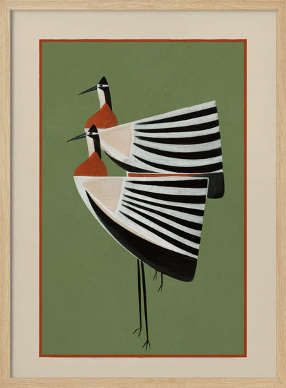 A framed art print featuring two highly stylized birds standing against a solid sage green background. The birds have boat-shaped bodies with bold black and white stripes, orange chests, and long thin black legs and beaks. Wall Art