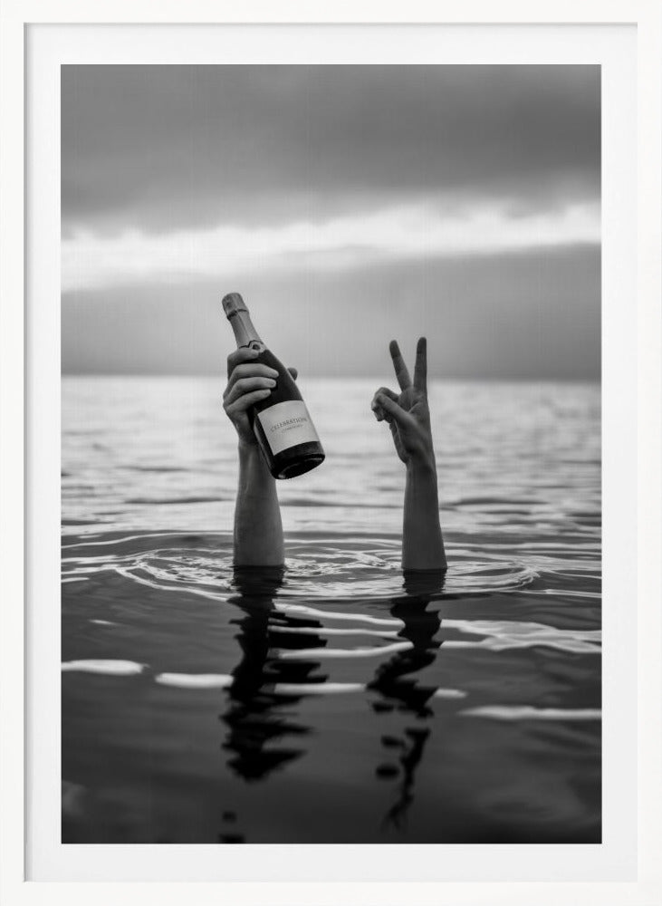 A black and white vertical photograph showing two arms sticking out of calm water. One hand holds a bottle of champagne, while the other makes a peace sign, all under a cloudy sky. Poster