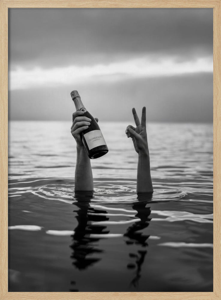A black and white vertical photograph showing two arms sticking out of calm water. One hand holds a bottle of champagne, while the other makes a peace sign, all under a cloudy sky. Poster