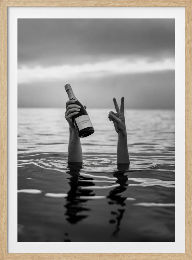 A black and white vertical photograph showing two arms sticking out of calm water. One hand holds a bottle of champagne, while the other makes a peace sign, all under a cloudy sky. Poster