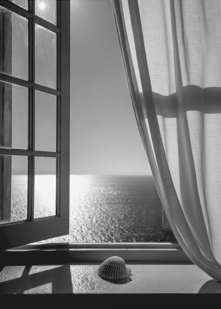 A serene black and white photograph looking out an open paned window at a sunlit ocean. A single seashell rests on the windowsill in the foreground, with shadows cast by the window frame. A light curtain hangs to the right, framing the tranquil sea view. Poster