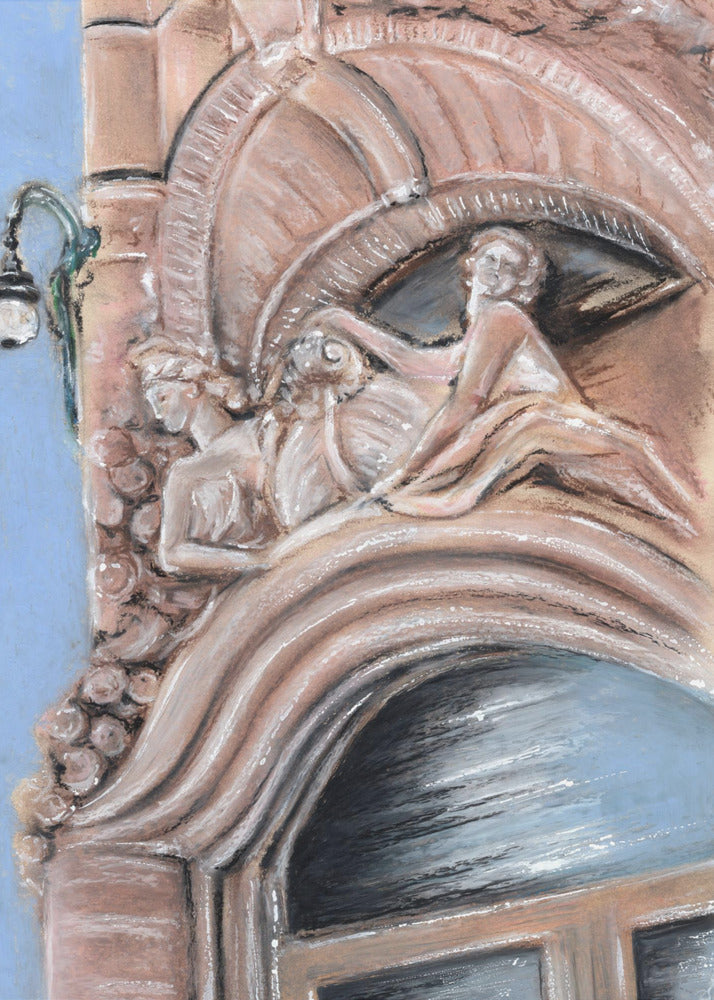 A pastel drawing of an ornate architectural detail on a building facade, featuring elaborate carvings above an arched window. The carvings depict classical female figures in flowing drapery, rendered in warm pink and brown tones against a light blue sky. A vintage-style street lamp is visible to the left. Wall Art