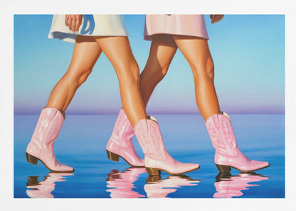 A pop art style painting of the legs of two women wearing matching pink cowboy boots and short skirts, walking across a reflective blue surface that mirrors their steps. The background is a gradient of blue and lavender, and the entire image is contained within a silver frame. Wall Art