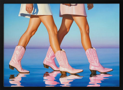 A pop art style painting of the legs of two women wearing matching pink cowboy boots and short skirts, walking across a reflective blue surface that mirrors their steps. The background is a gradient of blue and lavender, and the entire image is contained within a silver frame. Wall Art