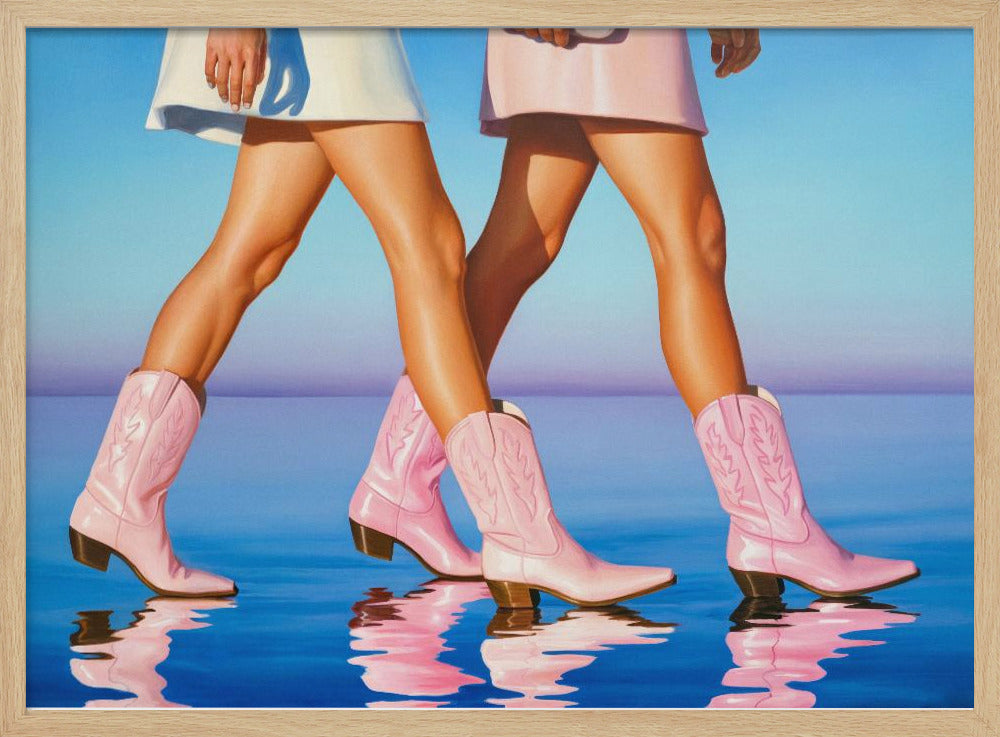 A pop art style painting of the legs of two women wearing matching pink cowboy boots and short skirts, walking across a reflective blue surface that mirrors their steps. The background is a gradient of blue and lavender, and the entire image is contained within a silver frame. Wall Art