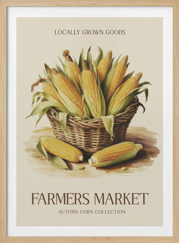 A vintage-style art print with a black frame featuring a wicker basket full of ears of corn. The poster has text that reads 'LOCALLY GROWN GOODS' at the top and 'FARMERS MARKET AUTUMN CORN COLLECTION' at the bottom. The background is a light cream color. Artwork
