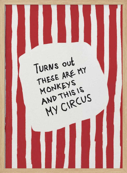 A framed art print featuring the humorous quote 'Turns out these are my monkeys and this is my circus' in black handwritten text. The text is centered on a white, cloud-like shape against a background of bold, hand-painted red and white vertical stripes, reminiscent of a circus tent. Poster
