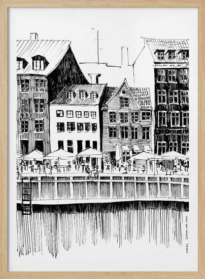 A black and white ink line drawing of a charming European city scene along a canal. Tall, narrow buildings with gabled roofs line the waterfront, in front of which is a bustling pier with outdoor cafes filled with people under umbrellas. The water's reflection is illustrated with simple vertical lines. The artwork is framed in black. Wall Art