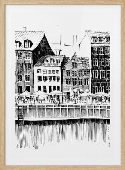 A black and white ink line drawing of a charming European city scene along a canal. Tall, narrow buildings with gabled roofs line the waterfront, in front of which is a bustling pier with outdoor cafes filled with people under umbrellas. The water's reflection is illustrated with simple vertical lines. The artwork is framed in black. Wall Art