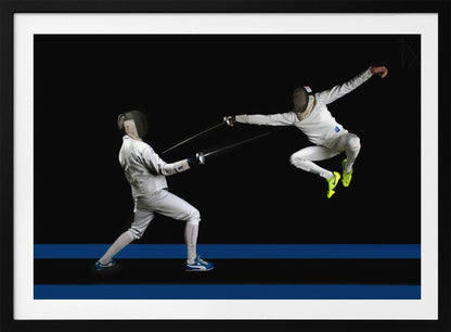 A dynamic action shot of two fencers in full white gear and masks dueling with foils against a stark black background. The fencer on the right is captured mid-air in a dramatic leap, while the fencer on the left lunges forward on a surface marked with blue lines. The image is enclosed in a silver frame. Artwork