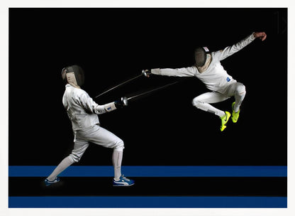 A dynamic action shot of two fencers in full white gear and masks dueling with foils against a stark black background. The fencer on the right is captured mid-air in a dramatic leap, while the fencer on the left lunges forward on a surface marked with blue lines. The image is enclosed in a silver frame. Artwork
