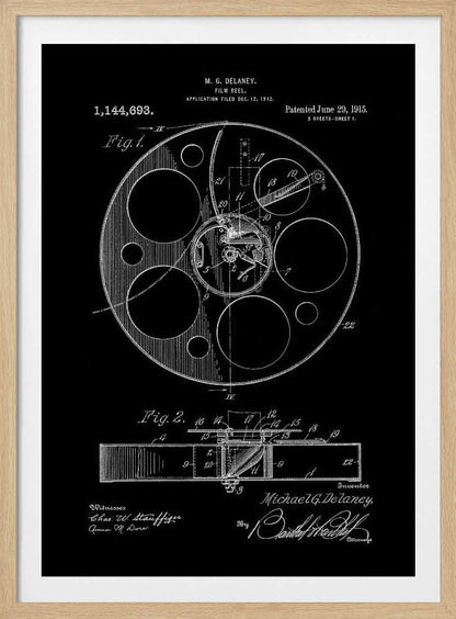A framed black and white patent illustration for a film reel, invented by M. G. Delaney in 1912. The drawing, presented as a negative image with white lines on a black background, shows detailed schematics of the reel's mechanism from a top-down view (Fig. 1) and a cross-section (Fig. 2). Poster