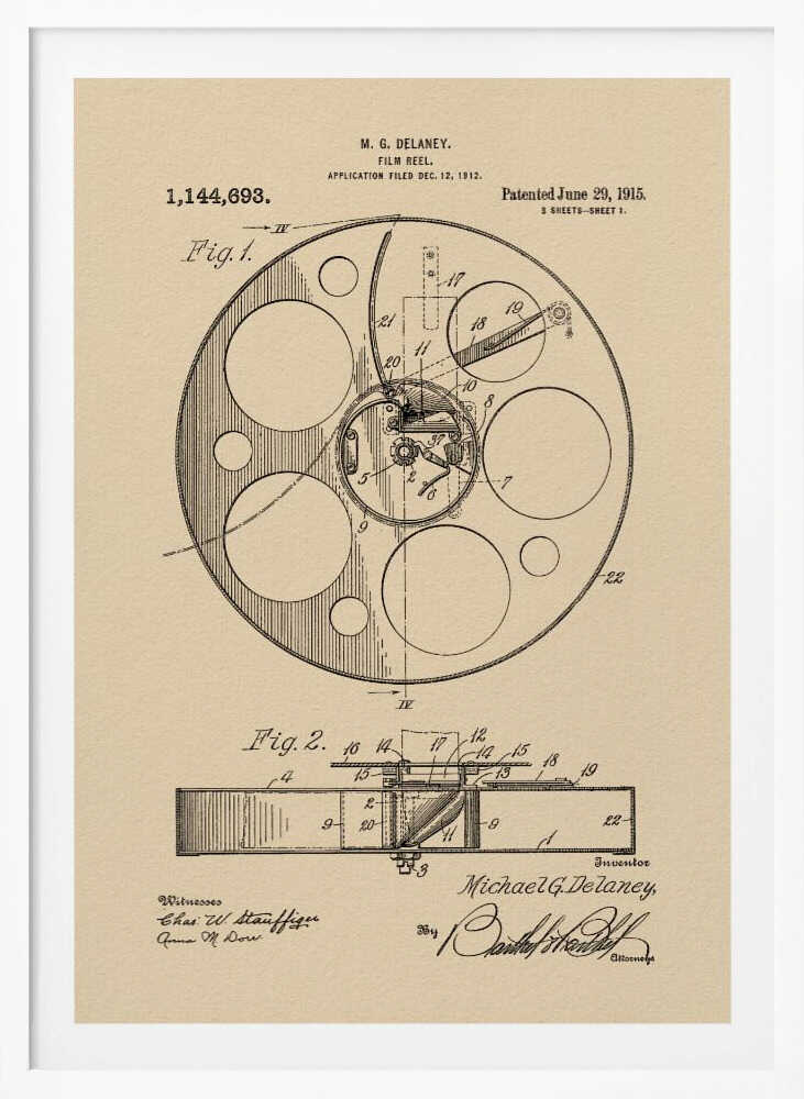 A framed vintage patent illustration of a film reel from 1915 by M.G. Delaney. The drawing is in black ink on a beige background, showing detailed schematics of the reel's mechanics from two different angles, complete with numbered parts, signatures, and patent information. Wall Art