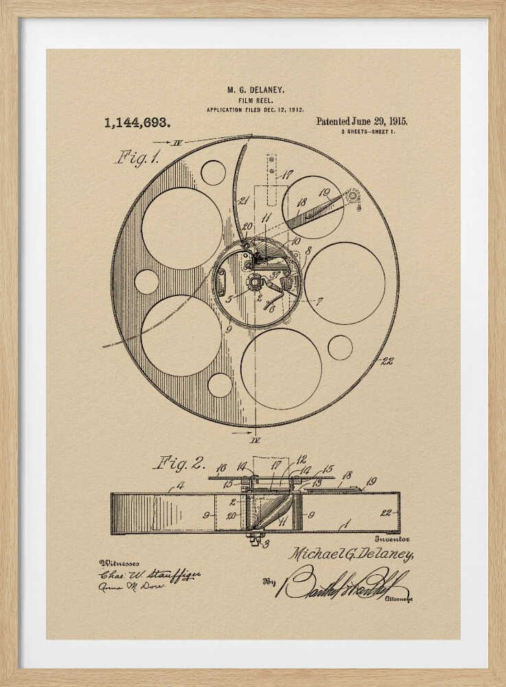 A framed vintage patent illustration of a film reel from 1915 by M.G. Delaney. The drawing is in black ink on a beige background, showing detailed schematics of the reel's mechanics from two different angles, complete with numbered parts, signatures, and patent information. Wall Art
