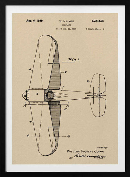 A framed vintage patent illustration of an airplane designed by W. D. Clark, dated August 6, 1929. The image shows a top-down schematic view of the aircraft in black ink on an aged, beige paper background, with various parts labeled with numbers. Text and signatures are visible, characteristic of an official patent document. Decor