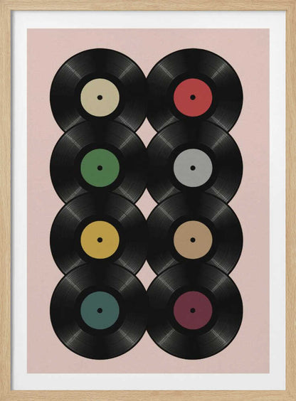 A graphic art print featuring eight black vinyl records arranged in two columns of four against a pale pink background. Each record has a different solid-colored label, creating a colorful and retro pattern. The artwork is enclosed in a simple black frame. Artwork