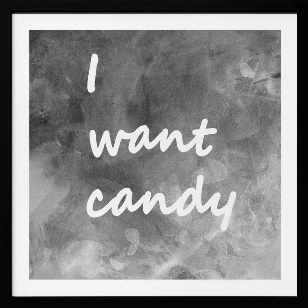 A framed typography art piece with a light brown wood frame. It features the phrase 'I want candy' in a white, handwritten script against a textured, dark gray and white chalkboard-style background. Wall Art