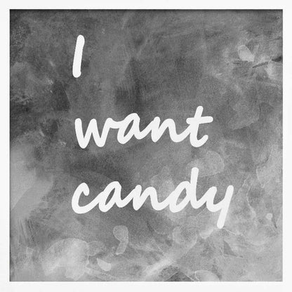 A framed typography art piece with a light brown wood frame. It features the phrase 'I want candy' in a white, handwritten script against a textured, dark gray and white chalkboard-style background. Wall Art