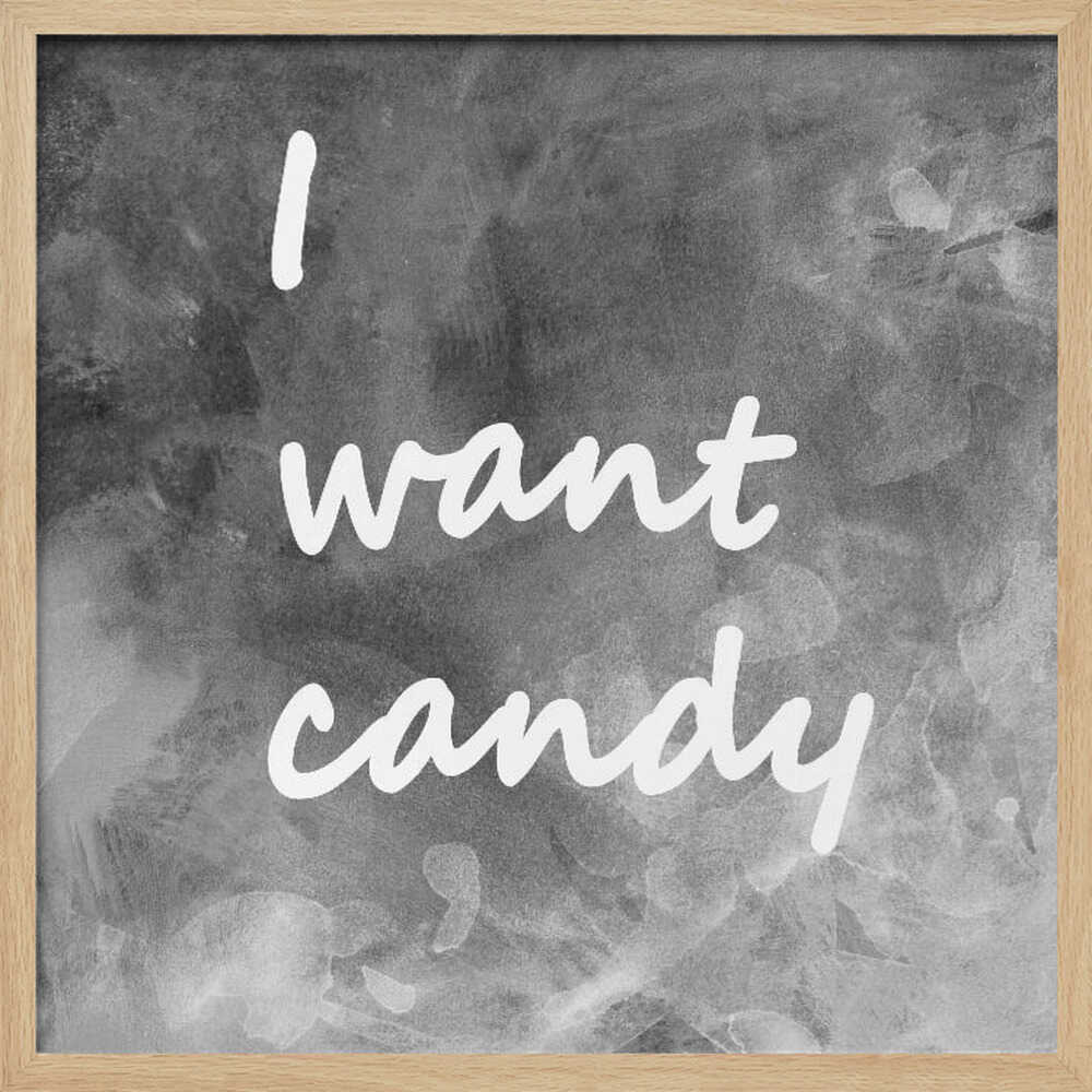 A framed typography art piece with a light brown wood frame. It features the phrase 'I want candy' in a white, handwritten script against a textured, dark gray and white chalkboard-style background. Wall Art